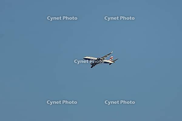 Embraer ERJ-190 jet commercial passenger aircraft of British airways airline flying in a blue sky, England, United Kingdom [IBR125423474]