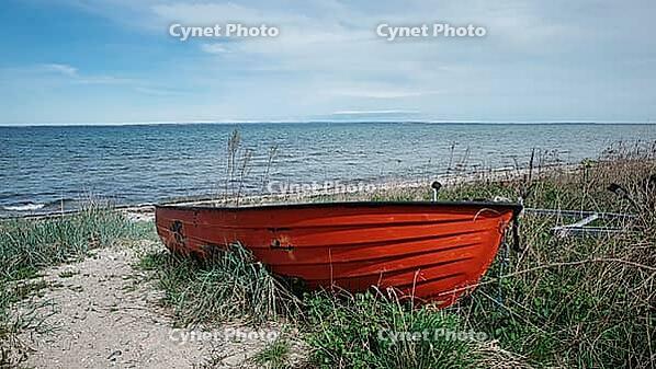 Red boat on the Baltic Sea, municipality of Sonderborg, Syddanmark region, Denmark [IBR125423480]
