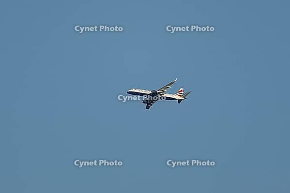 Embraer ERJ-190 jet commercial passenger aircraft of British airways airline flying in a blue sky, England, United Kingdom [IBR125423483]