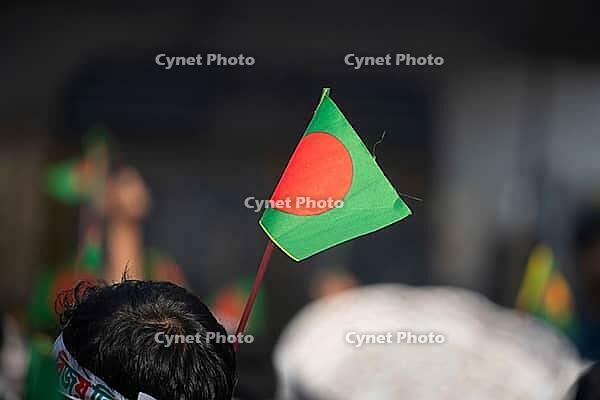 Dhaka, bangladesh- 16 Dec 2025: Bangladesh national flag held during a public celebratory event [IBR125423484]