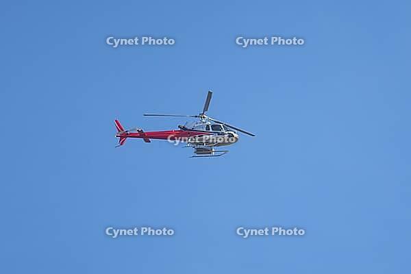 Eurocopter AS 350 B2 helicopter flying in a blue sky, England, United Kingdom [IBR125423493]