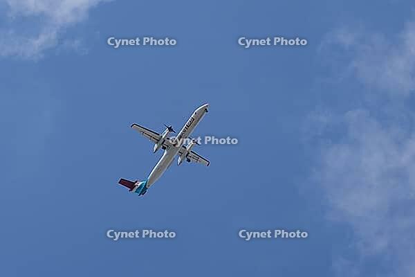 De Havilland Canada DHC-8-400 / Dash 8 Q400 turboprop commercial passenger aircraft of Luxair Luxembourg Airlines flying in a blue sky on approach to land at London city airport, England, United Kingdom [IBR125423496]