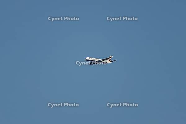 Embraer ERJ-190 jet commercial passenger aircraft of British airways airline flying in a blue sky, England, United Kingdom [IBR125423498]