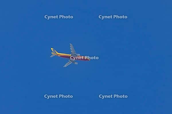 Jet cargo aircraft of DHL airline flying in a blue sky, England, United Kingdom [IBR125423499]