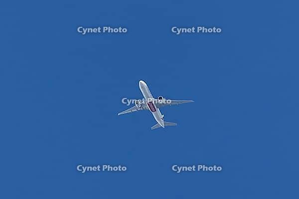 Boeing 777-300ER jet commercial passenger aircraft of Emirates airline flying in a blue sky, England, United Kingdom [IBR125423511]