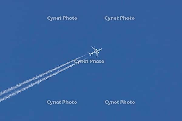 Jet commercial passenger aircraft of KLM airlines flying in a blue sky with contrails or vapour trails behind in the atmosphere, England, United Kingdom [IBR125423513]
