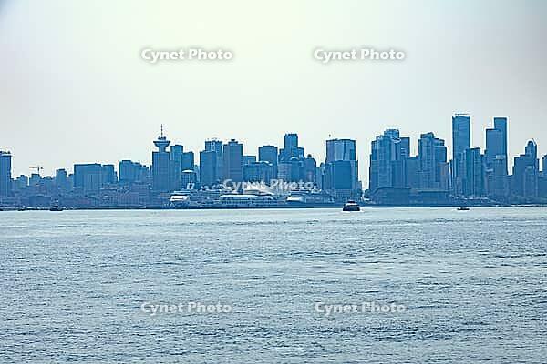 A panoramic view of the Vancouver cityscape featuring modern skyscrapers and large cruise ships docked along the harbor, Chadwick City, 220, Noth Vancouver, BC, Canada [IBR125424481]