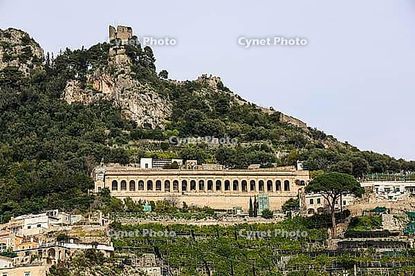 Amalfi town hillside showcasing old ruins, terraced gardens, and traditional architecture under a clear sky [IBR125436233]
