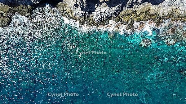 Atlantic Ocean water with underwater rocks washing against the coastline in Tenerife [IBR125436247]