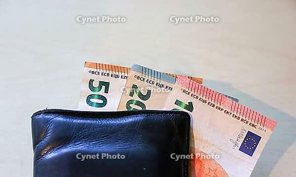 Wallet holding diverse Euro banknotes, representing financial transactions and wealth [IBR125436256]