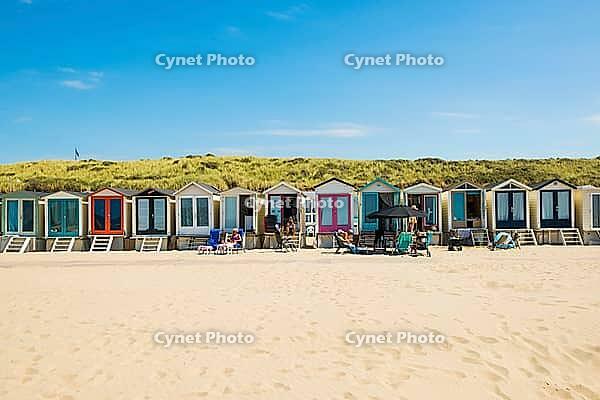 Sandy beach beach with beach huts and blue sky, Wijk aan Zee, North Sea, North Holland, Netherlands [IBR125436268]