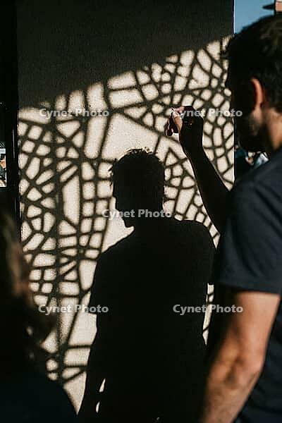 Shadow silhouette of a man cast upon a sunlit wall interlaced with intricate geometric lattice patterns, exploring themes of human consciousness, psychological fragmentation and the interplay between light and darkness, harsh chiaroscuro structures transf [IBR125446473]
