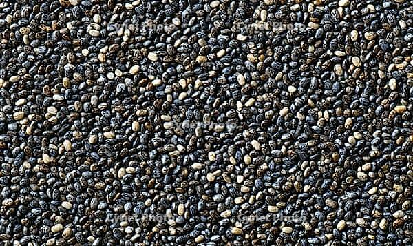 Straight-on texture of chia seeds densely packed, tiny black and gray seeds evenly distributed, AI generated [IBR125446483]