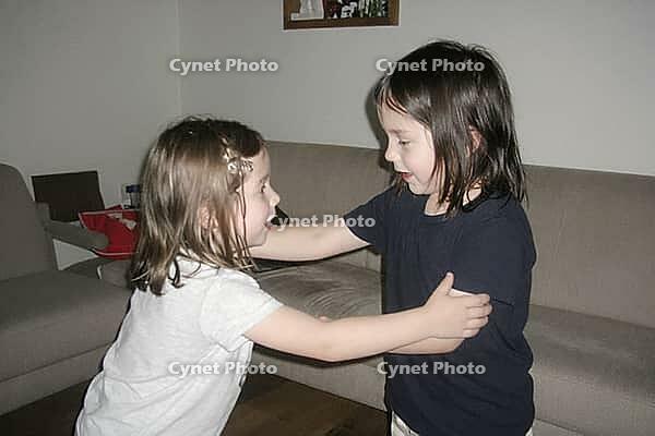 Two young siblings engage in spontaneous physical communication, emotional development and social bonding during indoor playtime in a domestic home, intimate tactile negotiation between toddlers exploring personal space boundaries and mutual affection, ex [IBR125446488]