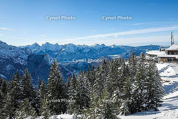 Mountain panorama and snowy mountain forest with Tegelberghaus, snowy mountain peaks of the Allg$00E4u and Ammergau Alps, at the summit of the Tegelberg in winter, mountain landscape, winter landscape, Tegelberg, F$00FCssen, Allg$00E4u, Bavaria, Germany [IBR125448823]