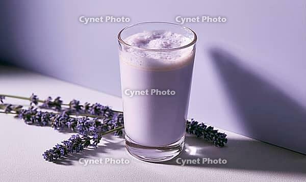 Lavender-flavored milk drink in clear glass beside dried lavender stems, AI generated [IBR125448890]