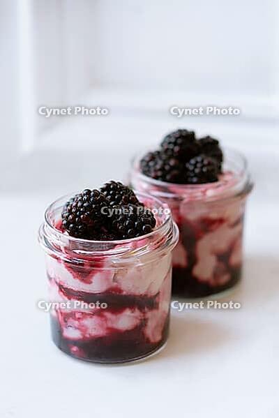 Creamy summer sundae dessert pots with berries and greek yogurt [IBR125462053]