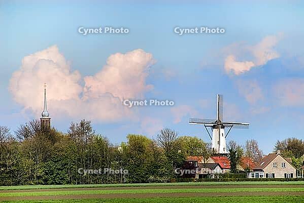 Landscape sight on little village with windmill and churchtower [IBR125462098]