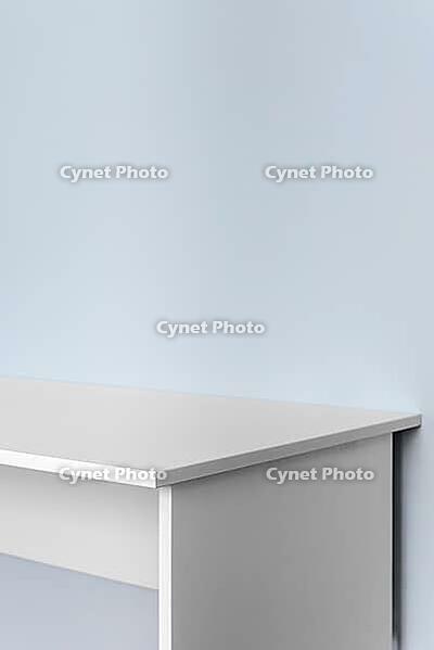 Minimal white desk against light blue wall. Cleaning interior background with copy space for product display, mockup or advertising design [IBR125462110]