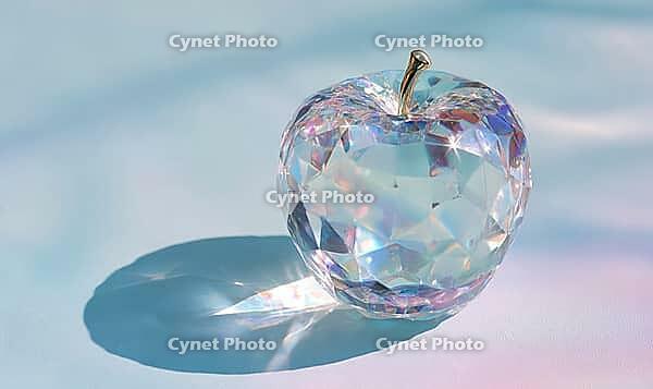 A shiny, colorful apple sits on a table. The apple is surrounded by a blue background, and the light shining on it creates a beautiful, AI generated [IBR125472309]
