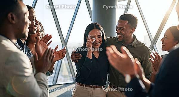 Emotional corporate promotion success, colleagues cheering crying woman in highrise office during recognition announcement, genuine tears of joy, psychological safety and deep empathy in corporate culture, hard earned triumph over systemic hurdles, authen [IBR125472320]