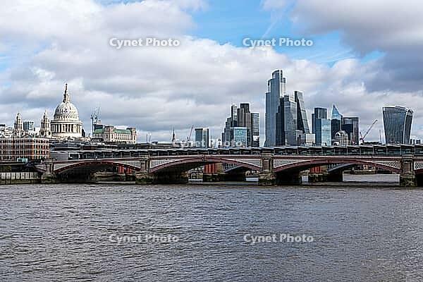 View of the River Thames in London with St. Pauls Cathedral and the skyscrapers of the city [IBR125492327]