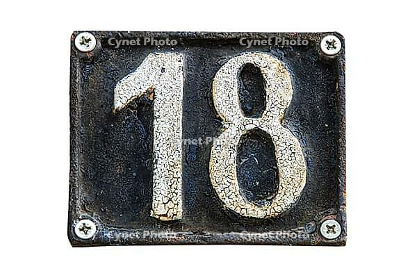 Old retro weathered cast iron plate with number 18 isolated on white background [IBR125492339]
