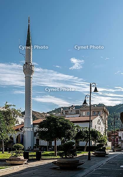 Marmaris, Turkey, 19.06.2026. Historical white mosque building with a tall minaret standing next to a green square on a sunny summer morning in Marmaris resort [IBR125492344]