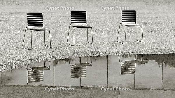 Black and white image of chairs by the water in front of the Bregenz Festival grounds in Bregenz on Lake Constance [IBR125492380]