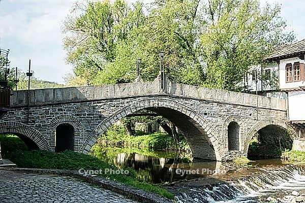 Old stone bridge over river in old town of Tryavna, Bulgaria [IBR125492408]