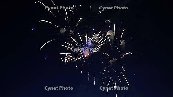 Colorful fireworks exploding in the dark night sky, creating a spectacular display of light and color during a festive celebration [IBR125501571]