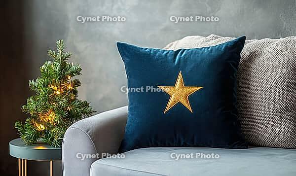 Dark blue velvet pillow with a single golden star embroidery, placed on a light gray couch, AI generated [IBR125502183]