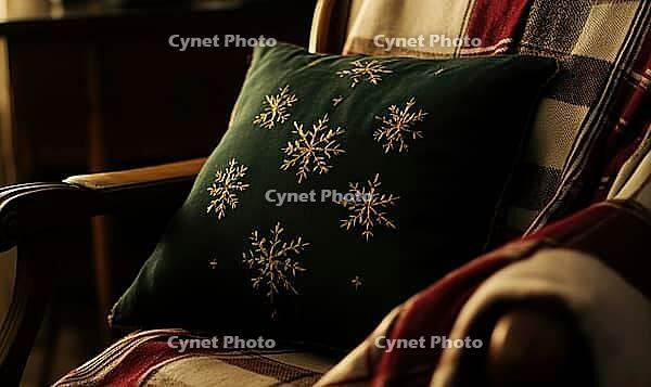 Small dark green pillow with golden snowflake embroidery on a wooden armchair, AI generated [IBR125502205]