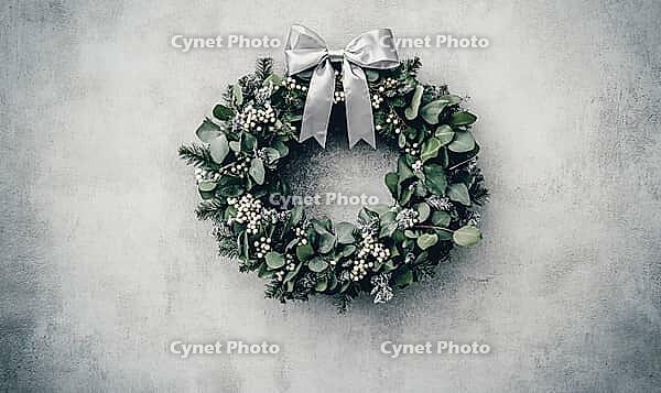 Christmas wreath made of eucalyptus and white holly berries, with a thin silver ribbon bow at the top, AI generated [IBR125502216]