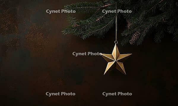 Single brass star ornament hanging on a green pine branch against a dark brown wall, warmly lit to create a festive atmosphere, AI generated [IBR125502220]