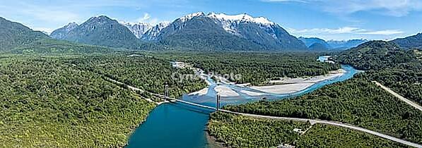 Bridge, river Rio Frio and Rio Yelcho at the end of Lago Yelcho, picturesque mountains with snow-capped peaks, Puerto Cardénas, Carretera Austral, Patagonia, Los Lagos, Chile [IBR125521094]