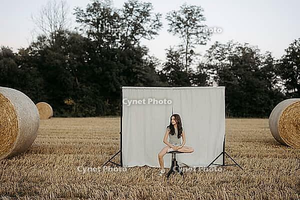 Brown-haired girl, 11, in a cornfield against a beige background [IBR125521125]