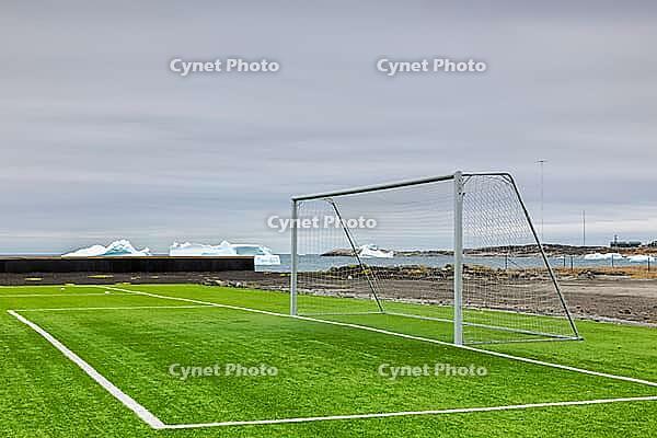 Football field in front of iceberg, goal, artificial turf, Quaqertarusaq, Disco Island, West Greenland, Greenland [IBR125521127]