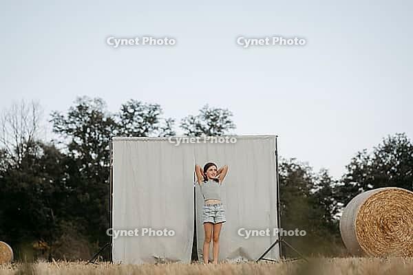 Brown-haired girl, 11, in a cornfield against a beige background [IBR125521151]