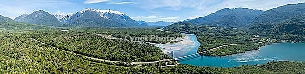 Aerial view, bridge, Rio Yelcho river at the end of Lago Yelcho, picturesque mountains with snow-capped peaks, Puerto Cardénas, Carretera Austral, Patagonia, Los Lagos, Chile [IBR125521168]