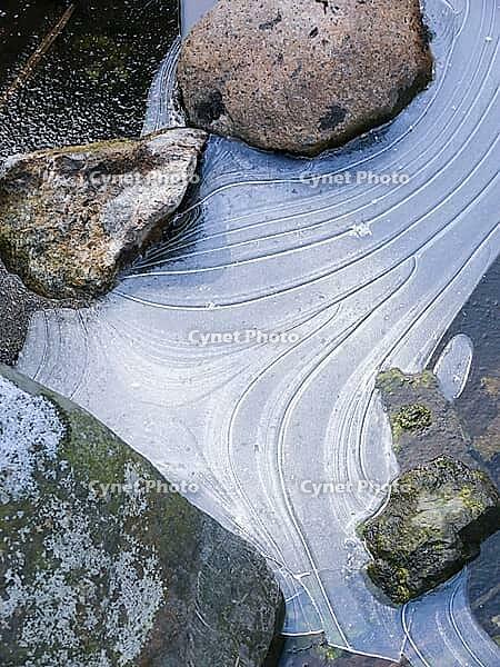 Stones in a frozen stream Stones in a frog creek [IBR125527024]