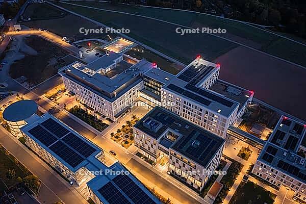 A modern building complex at night from above with glowing street lights, hospital and health campus, Klinikverbund Südwest, Calw, Germany [IBR125527030]