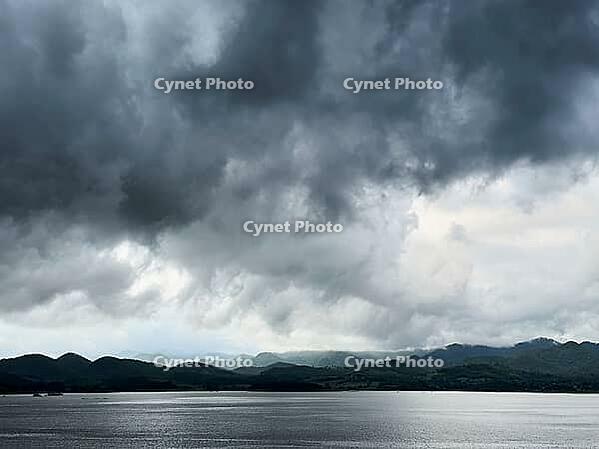 Large lake and mountain with cloudy dark sky [IBR125527031]