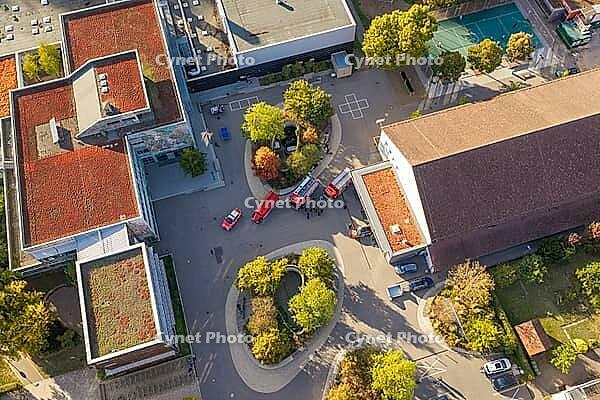 Aerial view of a paved square with fire engines between modern buildings and small groups of trees, Nagold, Calw district, Germany [IBR125527053]