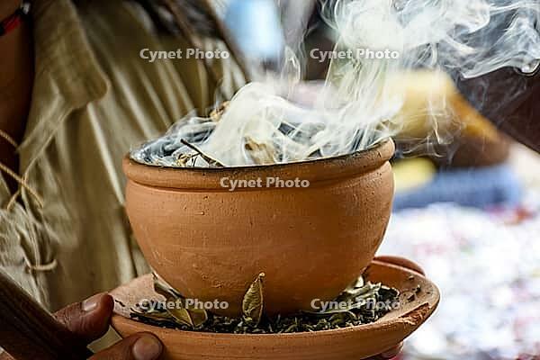 Aromatic herbs burning from a clay pot at the Umbanda smoking ceremony in Brazil [IBR125527090]