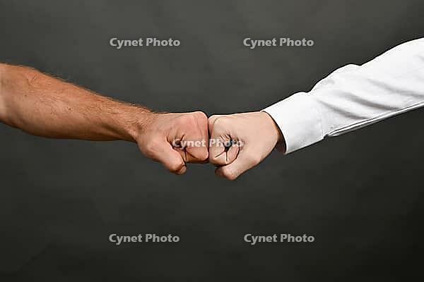 Collision of two fists. Competition or approval concept [IBR125527099]