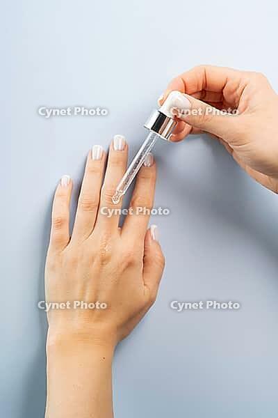 Hand skin care oil or serum dropper bottle beauty concept mockup [IBR125527112]