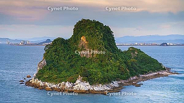 Yatsushiro, Kumamoto Pref, Japan - Oct 9 2024, panoramic aerial view of an uninhabited island covered with forest off coast of Yatsushiro, at daytime with cloudy sky, Yatsushiro, Japan [IBR125536388]