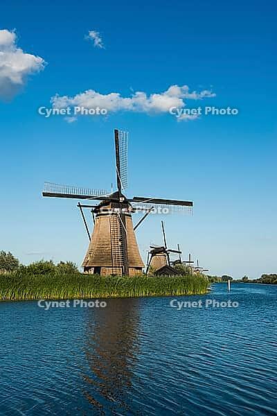 Historic windmills with blue sky on the river, UNESCO World Heritage Site, Kinderdijk, near Rotterdam, province of South Holland, Netherlands [IBR125536390]