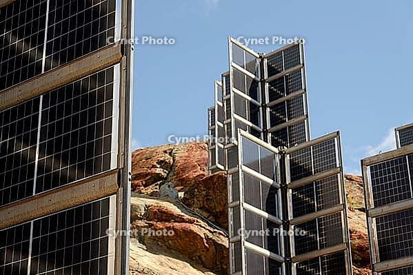 Detail of solar panels in mountains vertically mounted as four wings around central column like tree, photovoltaic plant avoid snow accumulation, future innovation energy concept [IBR125536397]